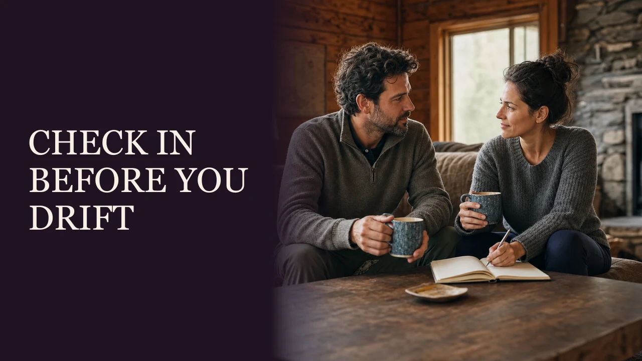 A mature couple talking thoughtfully on a botanical-garden bench beside the words Check In Before You Drift.